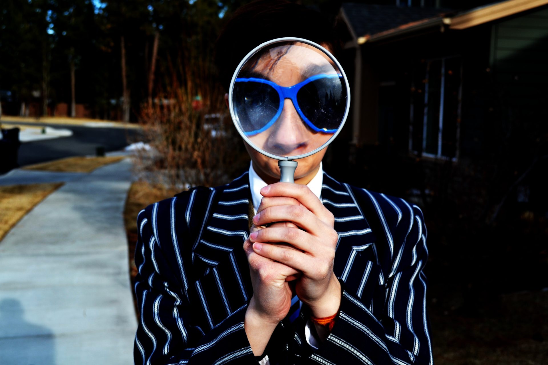 Image of a man staring through a magnifying glass