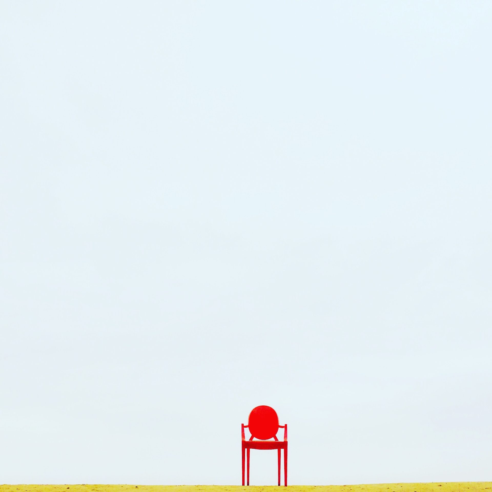 Minimalist setting of one red chair